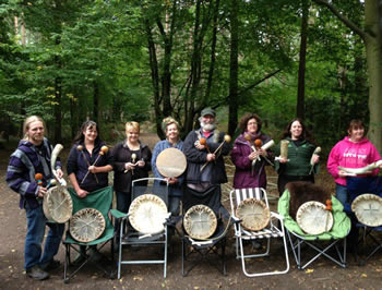 Drum and ancient instrument making workshop attendees with their finished instruments